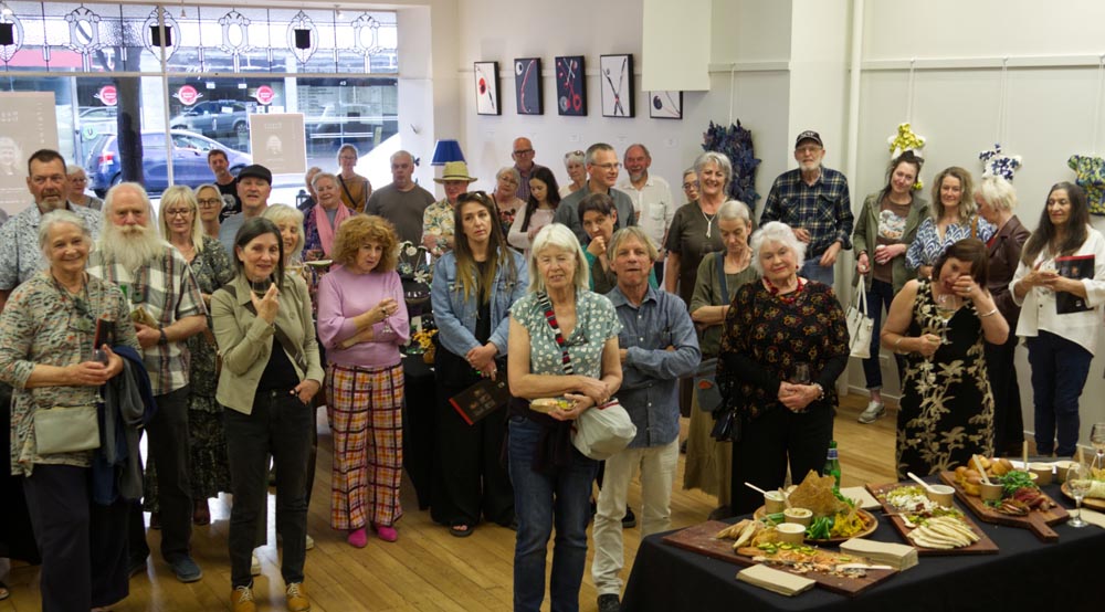More than 100 guests listening to speeches at the opening of Maggie Treweek's exhibition